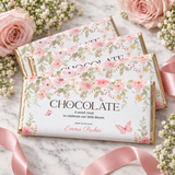 Stack of chocolate bars in baby in bloom wrappers with pink roses and ribbon