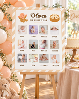 Little dumpling 1st birthday milestone board with 12 baby photos on a wooden easel next to a peach balloon garland