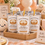 Little dumpling juice pouches with printed labels in a bamboo tray on a party drinks table