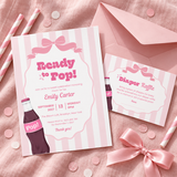 Ready To Pop diaper raffle card tucked behind the matching pink striped baby shower invitation with a blush envelope