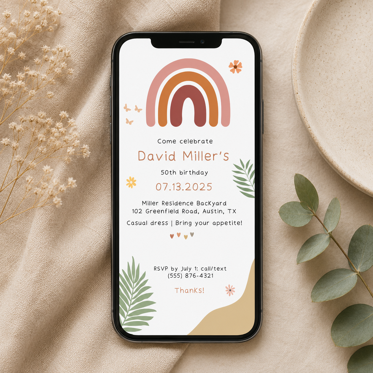 Boho rainbow birthday invitation in terracotta and sage with scattered flowers