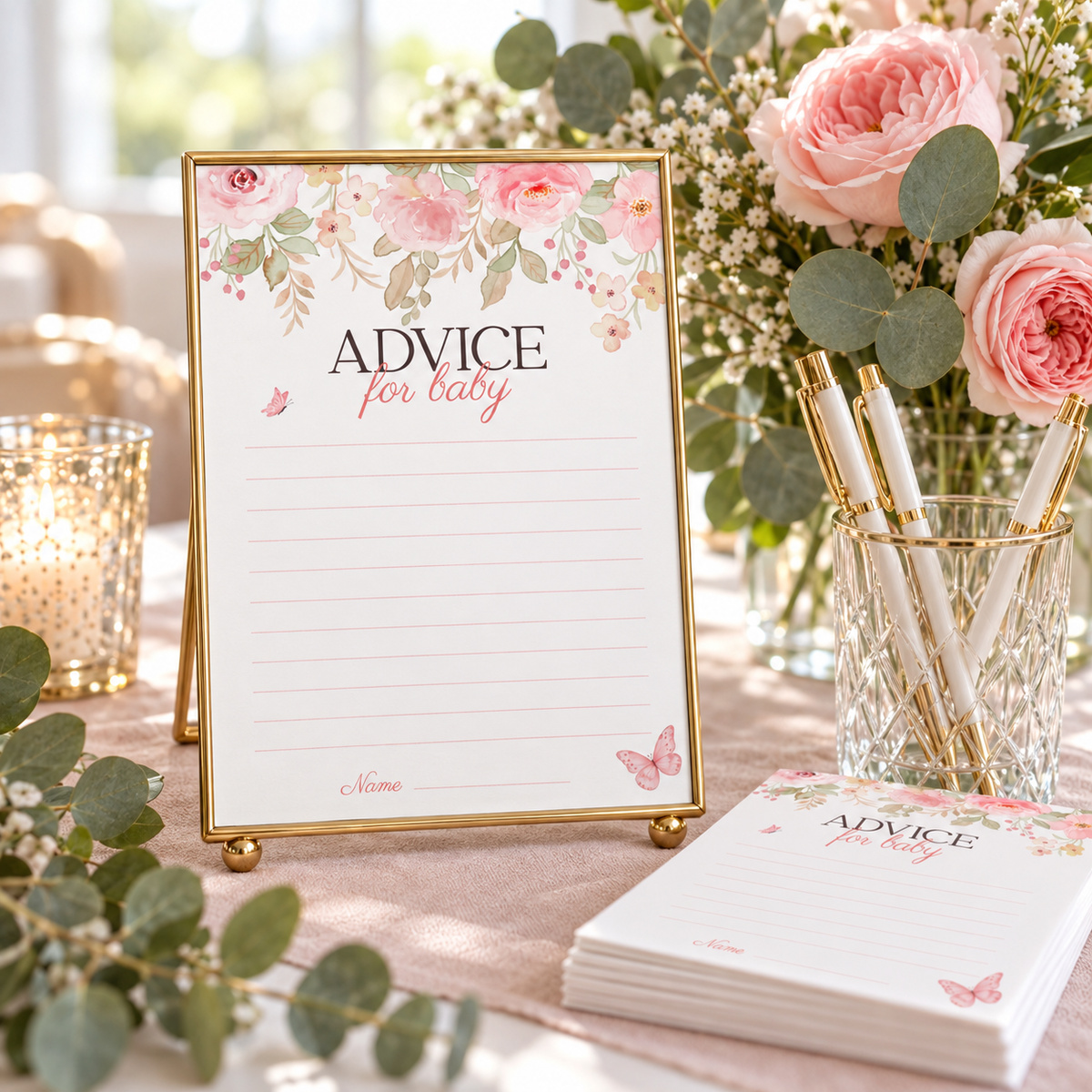 Baby in bloom advice for baby card in a gold frame on a shower table with roses and pens