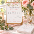 Baby in bloom baby predictions card in a gold frame on a shower table with roses and pens