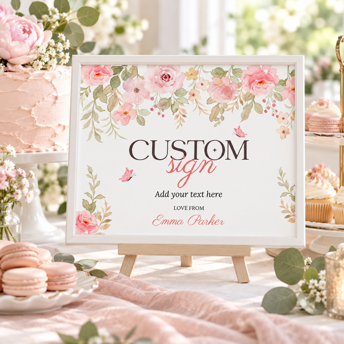 Landscape baby in bloom custom sign on an easel at a pink dessert table