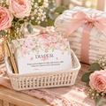 Baby in bloom diaper raffle cards in a white basket next to diapers tied with blush ribbon