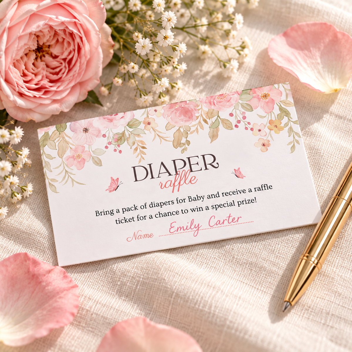 Close-up of a pink floral diaper raffle card filled in with a guest name