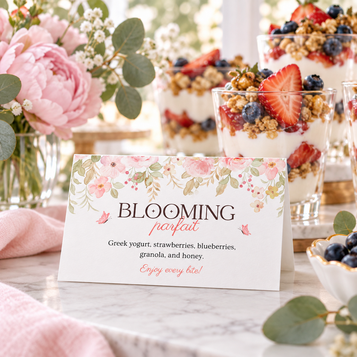 Baby in bloom food label tent card in front of berry parfait cups