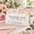 Baby in bloom folded thank you card standing on a linen table with pink roses and tea