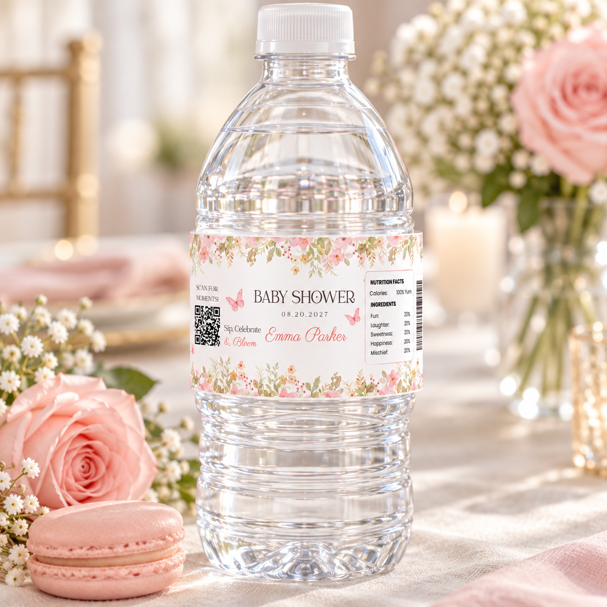 Close-up of a baby shower water bottle label with pink floral border and QR code
