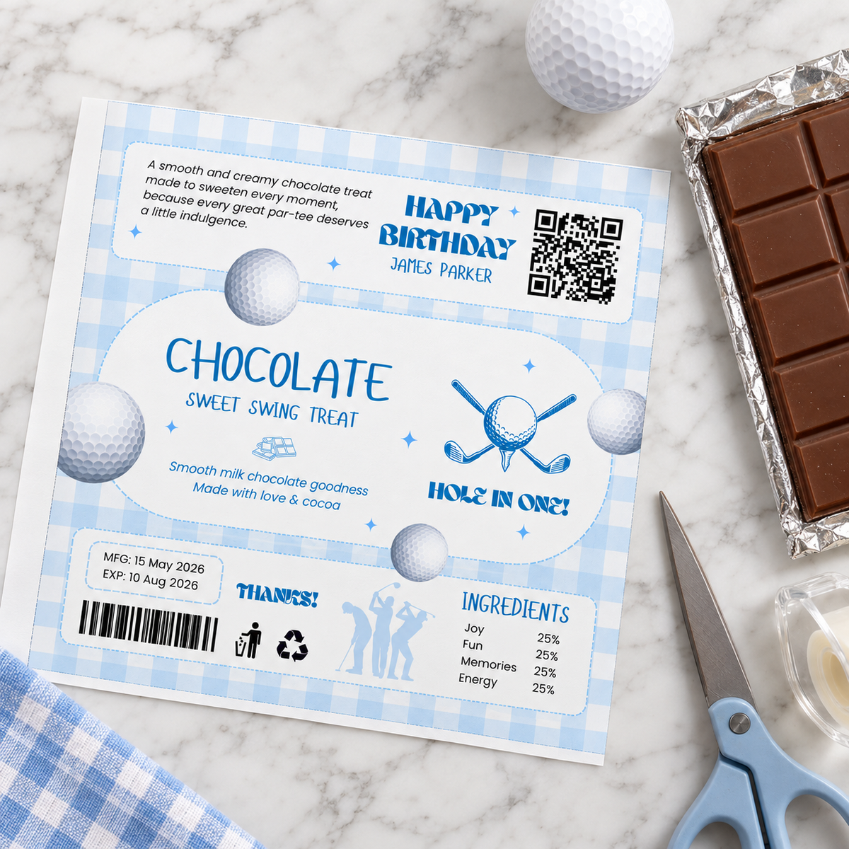 Printed golf chocolate bar wrapper flat lay next to a chocolate bar, scissors and tape