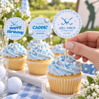 Hand placing a personalized golf name cupcake topper on a first birthday dessert table