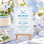 Golf 1st birthday invitation on an easel next to a smash cake with a golf flag