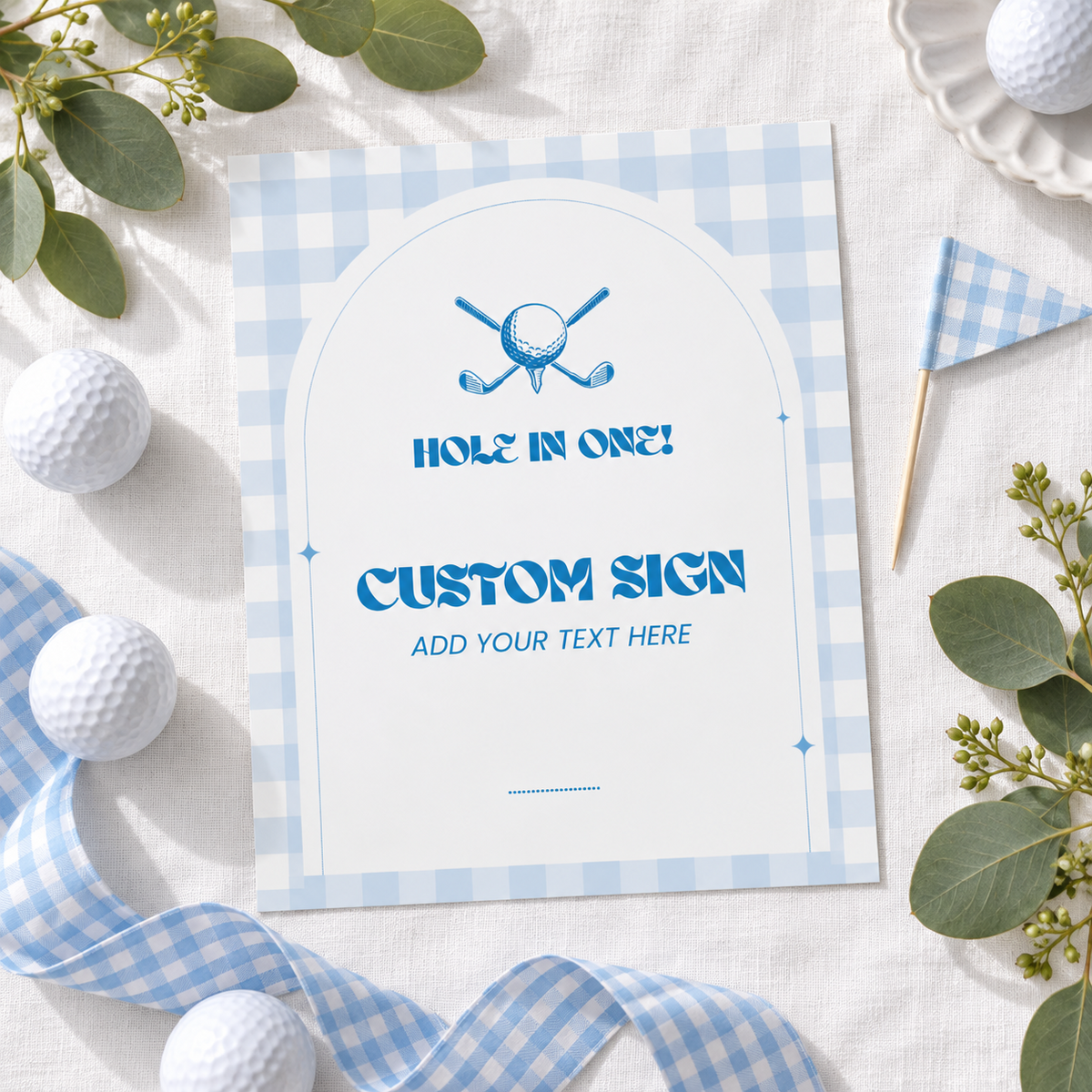 Printed golf custom party sign flat lay with golf balls, gingham ribbon and eucalyptus