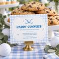 Golf hole in one 1st birthday food label in a gold card holder in front of chocolate chip cookies