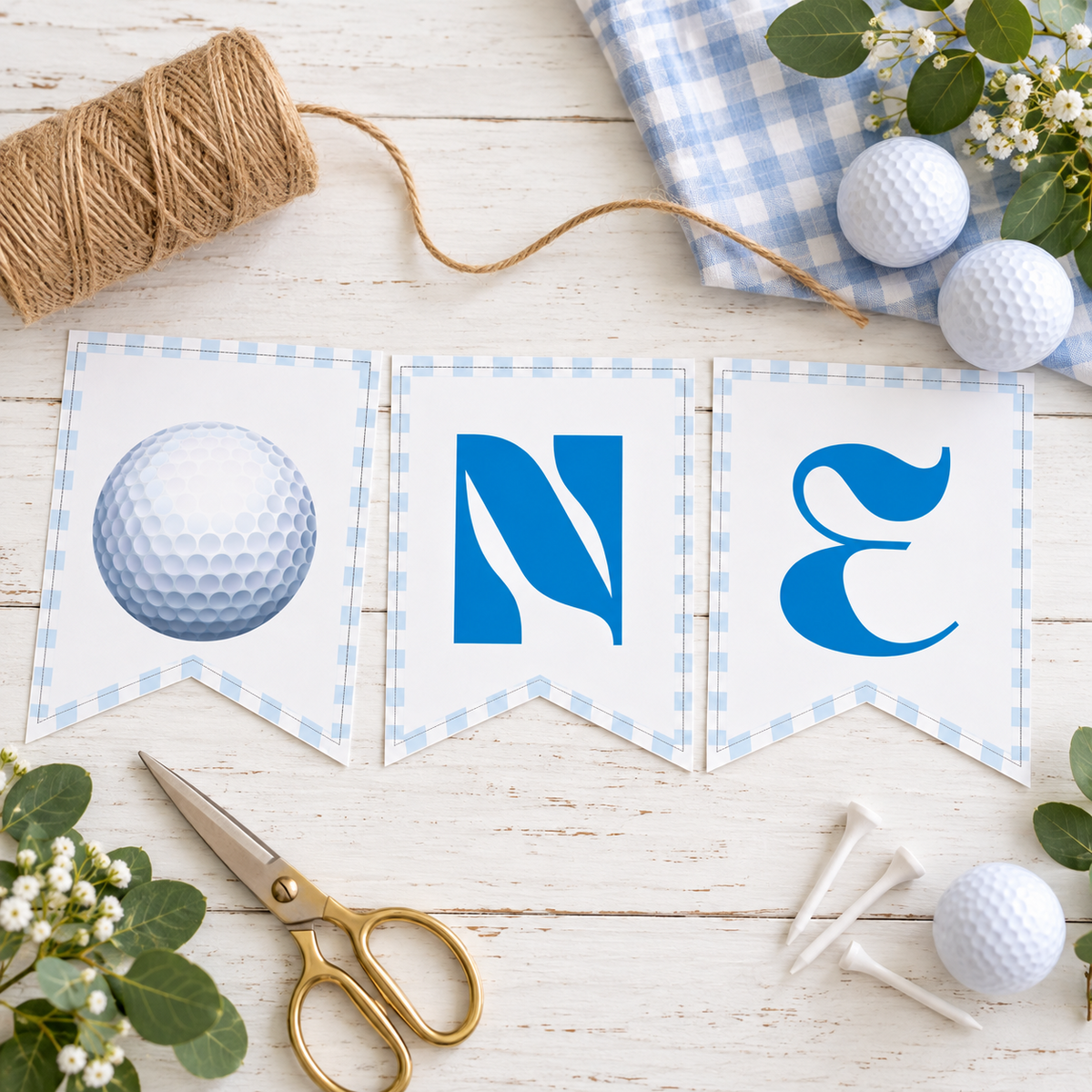 Flat lay of the printed golf ball O, N and E pennants with twine and golf balls