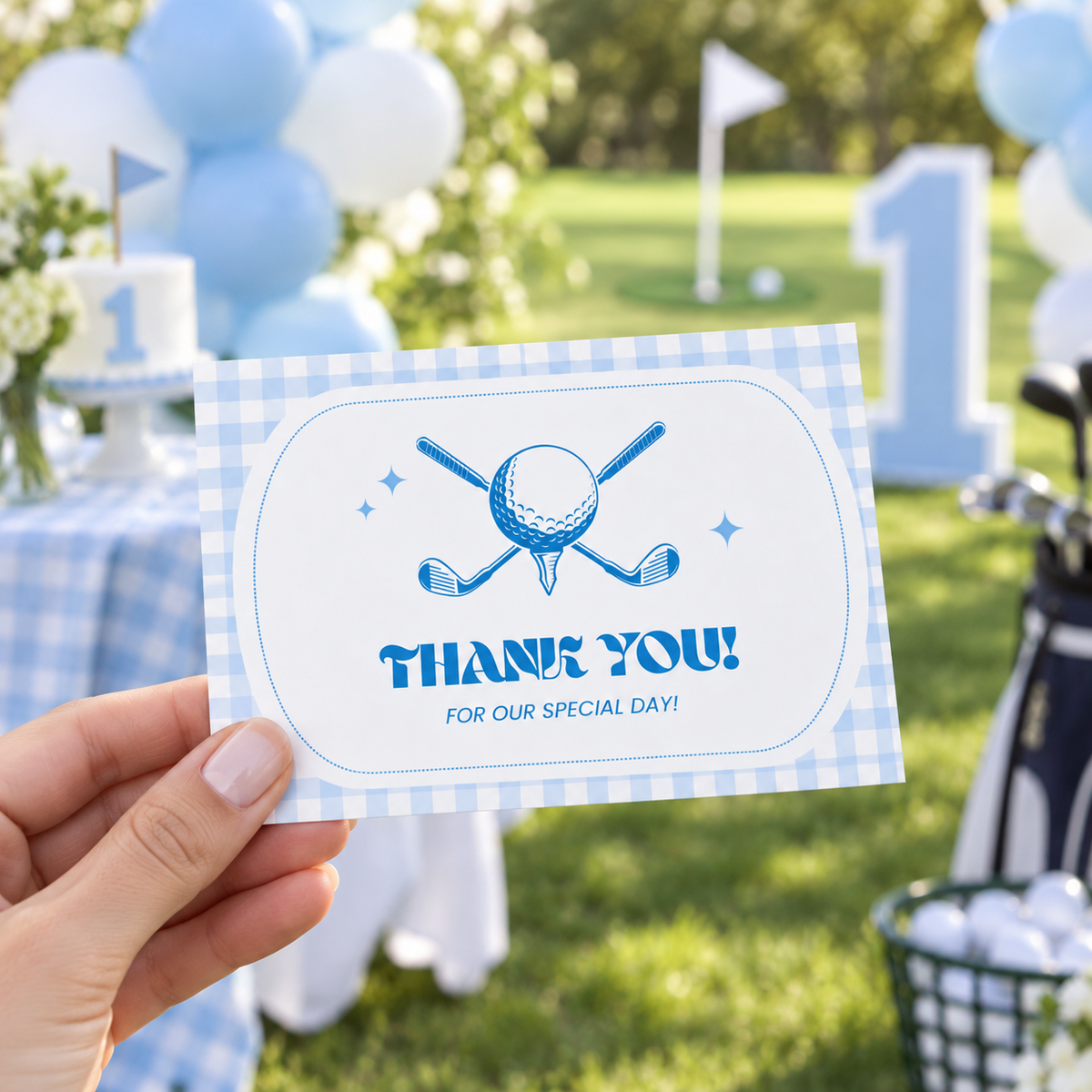Hand holding golf first birthday thank you card at an outdoor party
