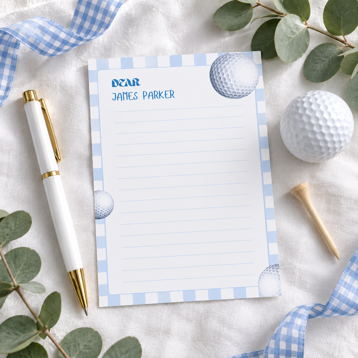 Printed golf first birthday time capsule card flat lay with pen, golf ball and tee