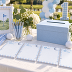 Golf time capsule cards on a guest table with pens and a card box at an outdoor first birthday