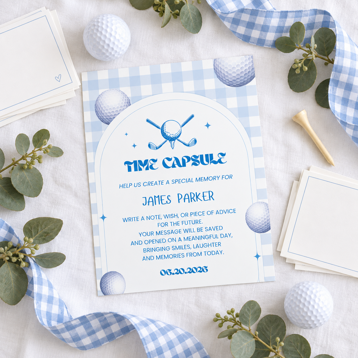 Printed golf first birthday time capsule sign flat lay with note cards, golf balls and gingham ribbon