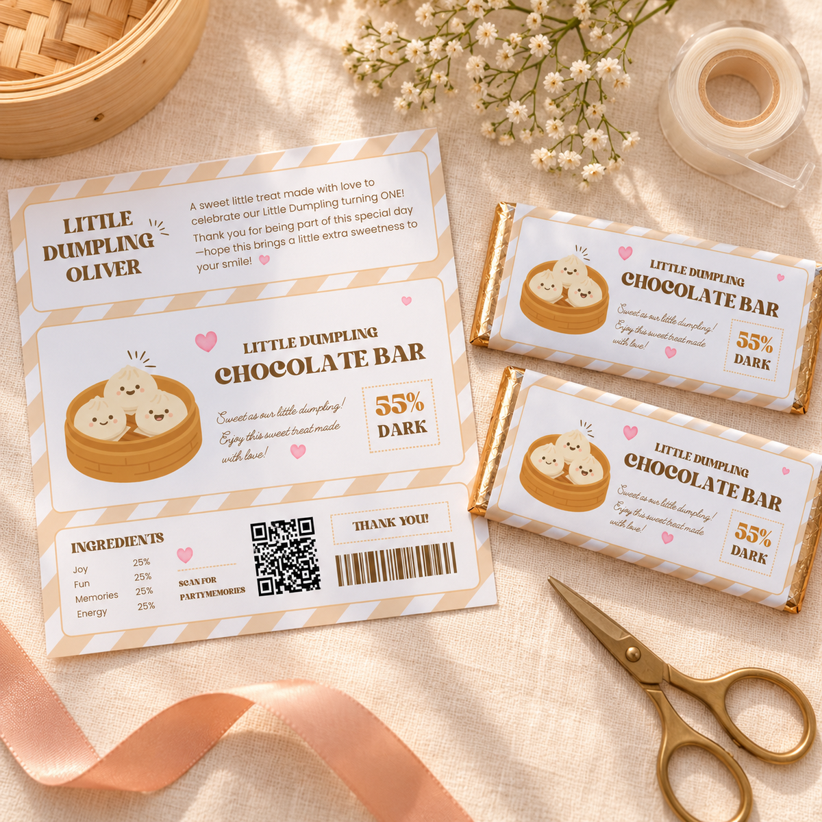 Flat lay of the printed little dumpling chocolate wrapper sheet with two wrapped bars and scissors