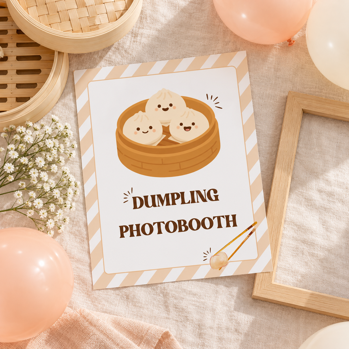 Flat lay of the printed little dumpling 8x10 sign with a wooden frame and balloons