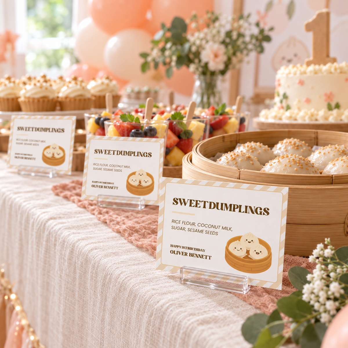 1st birthday buffet table with little dumpling food labels in front of each dish