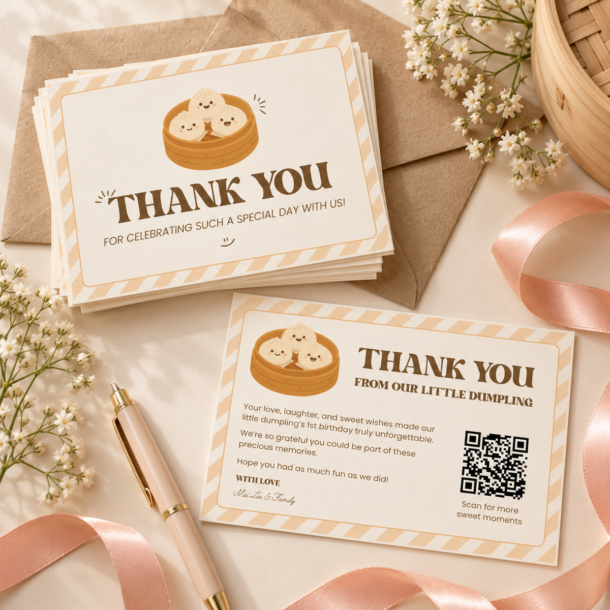Flat lay of printed dumpling thank you cards with kraft envelopes, a peach ribbon and baby's breath
