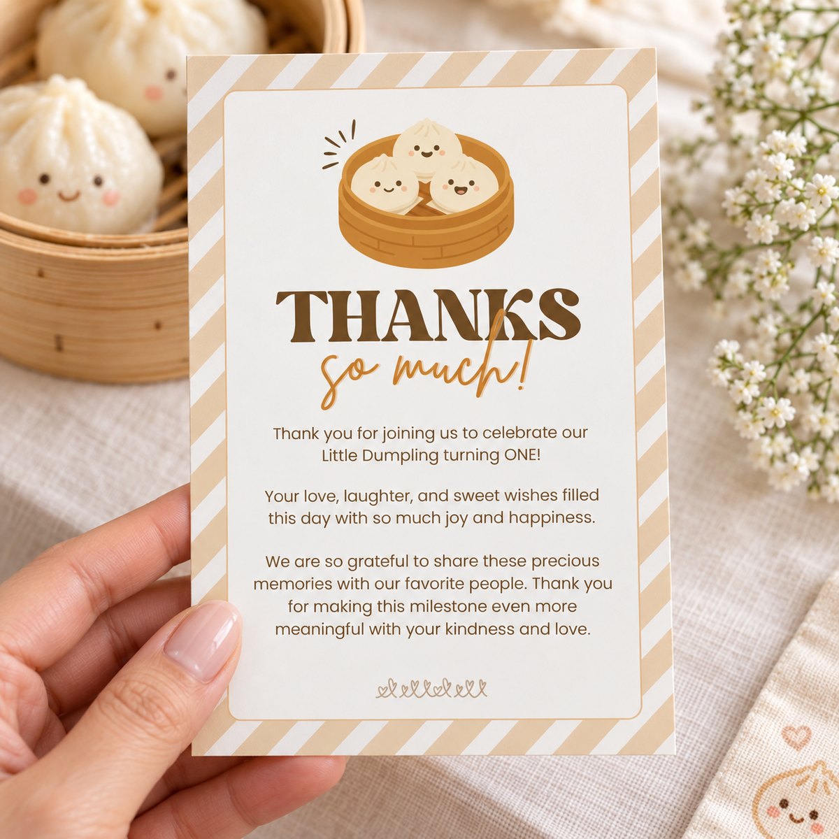 Close-up of the printed little dumpling thank you card held in hand