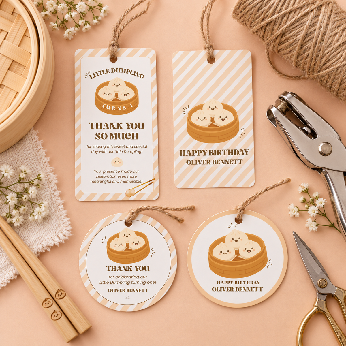 Flat lay of printed little dumpling favor tags with twine and a hole punch