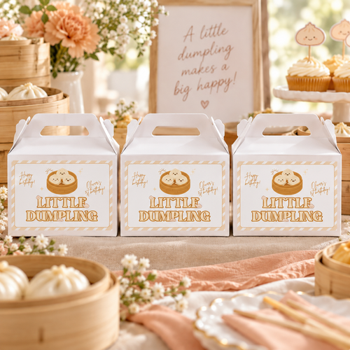 Little dumpling gable favor boxes with printed labels on a party dessert table