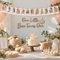 Little dumpling monthly photo banner hanging above a 1st birthday dessert table