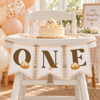 Little dumpling ONE banner hanging on a white high chair at a 1st birthday