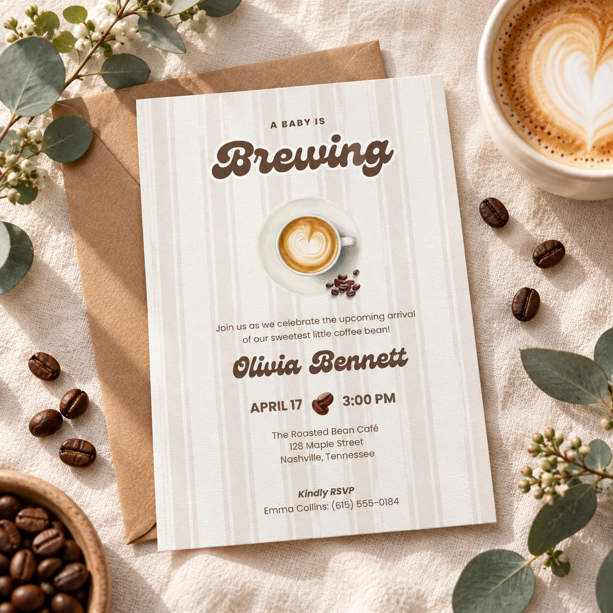 Coffee baby shower invitation flat lay with kraft envelope, coffee beans and eucalyptus