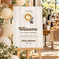 Baby Is Brewing coffee baby shower welcome sign on a wooden easel with cream and brown balloons and a latte bar
