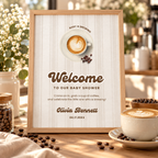 Baby Is Brewing welcome sign in a wooden frame on a table with coffee beans and a latte