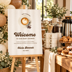 Coffee baby shower welcome sign next to a coffee bar with mugs and pastries