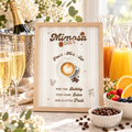 Baby Is Brewing mimosa bar sign in a wood frame on a brunch mimosa bar with champagne flutes and orange juice
