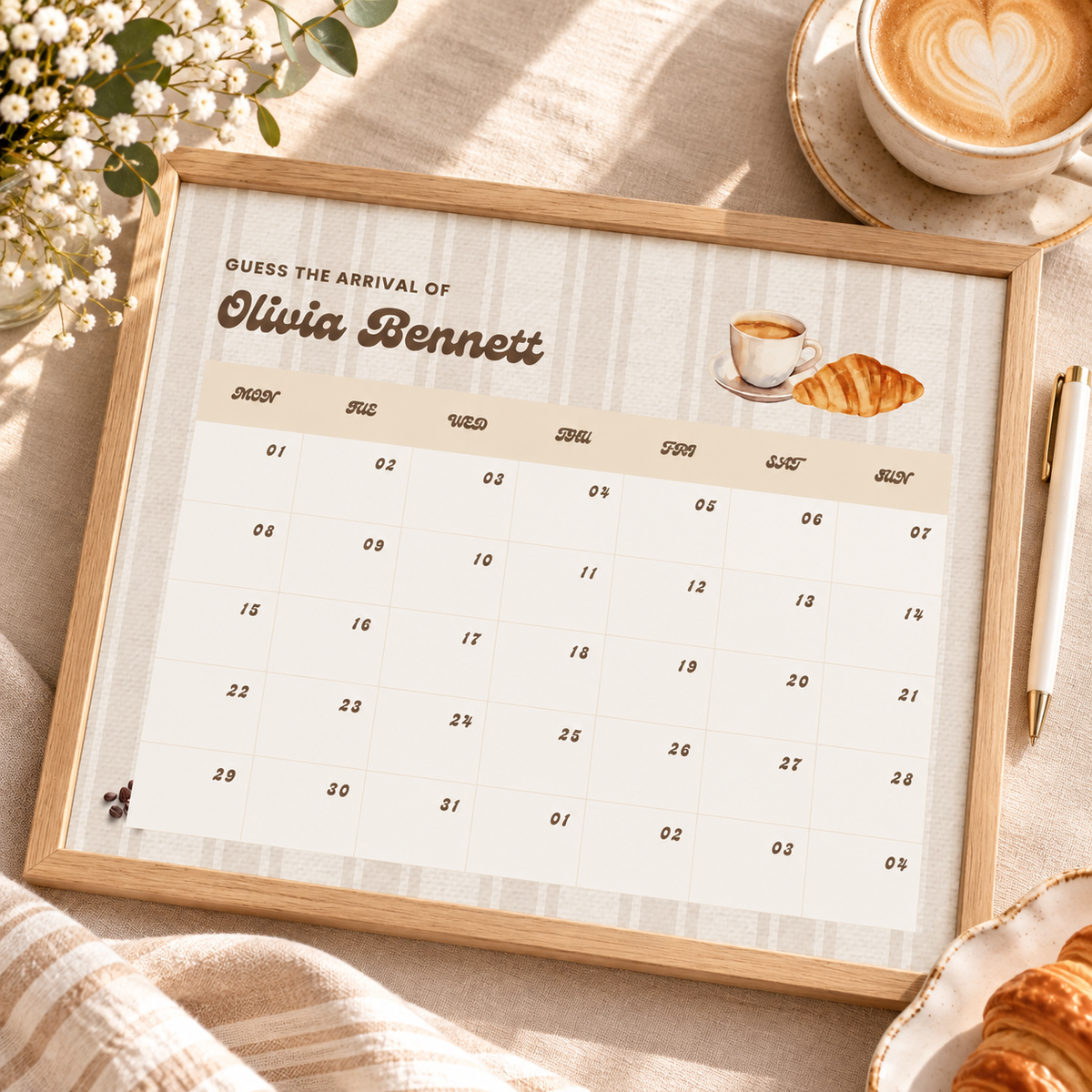 Framed Baby Is Brewing due date calendar with a pen and a latte