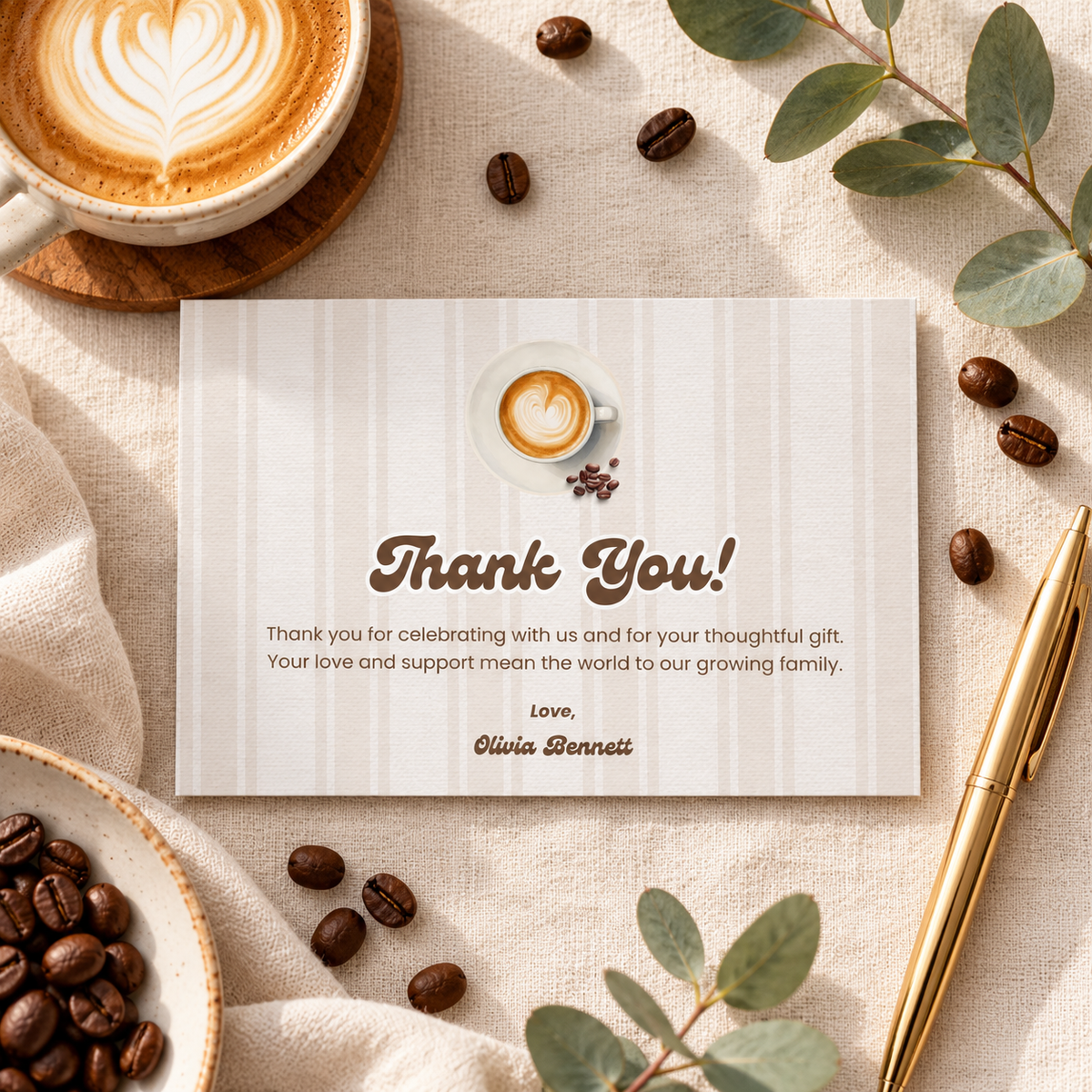 Baby Is Brewing thank you card flat lay with coffee beans, gold pen and eucalyptus