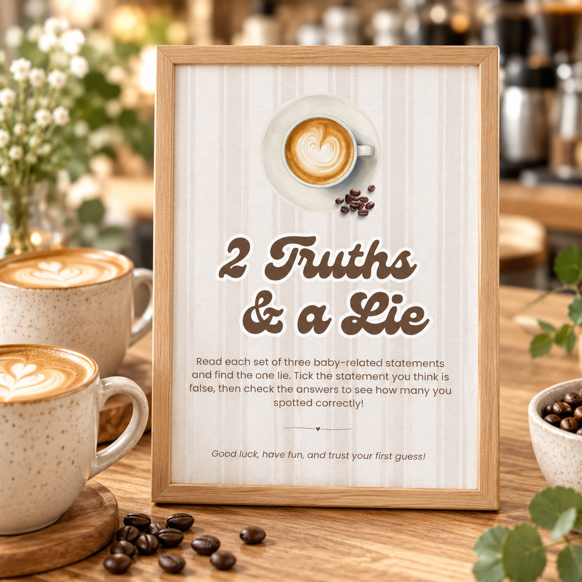 Close-up of the Baby Is Brewing 2 Truths and a Lie game sign on a cafe counter with lattes