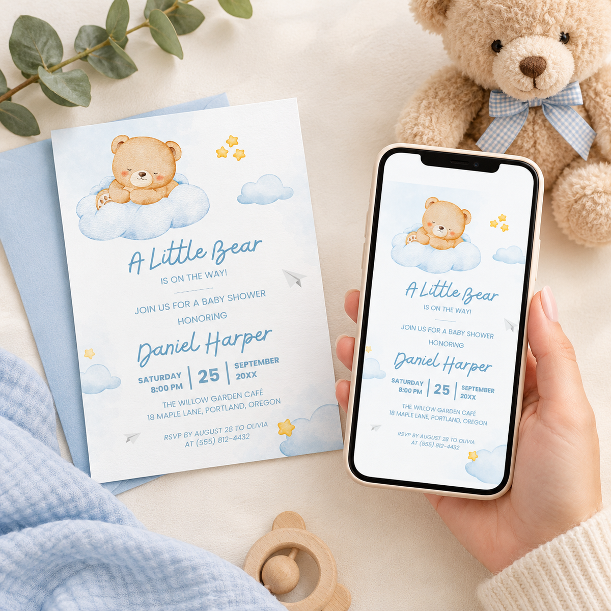Little Bear baby shower e-vite on a phone next to the printed invitation