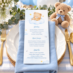 Little Bear baby shower menu card on a plate with a blue napkin, gold cutlery and a teddy bear