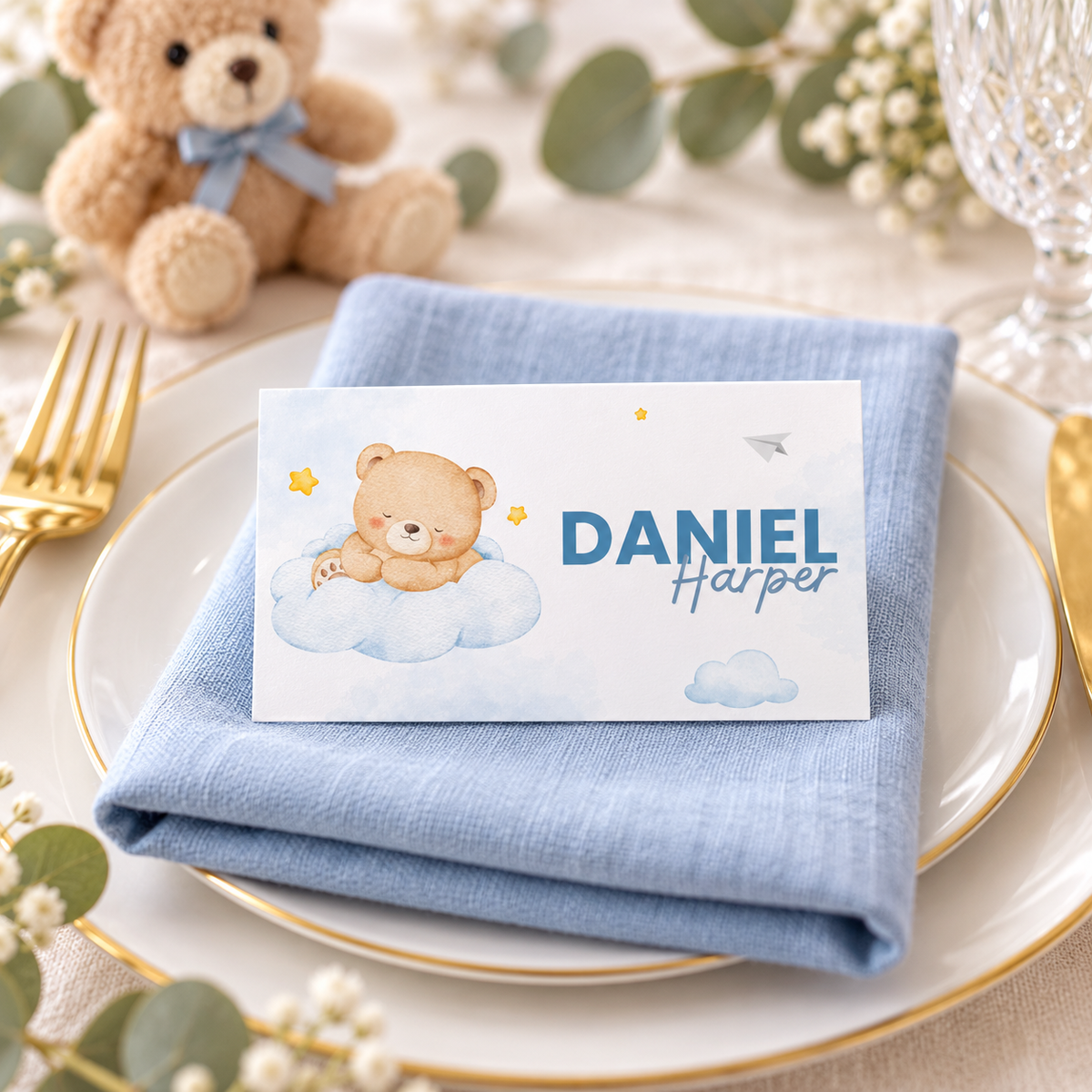Little Bear teddy bear baby shower place card on a plate with a blue linen napkin