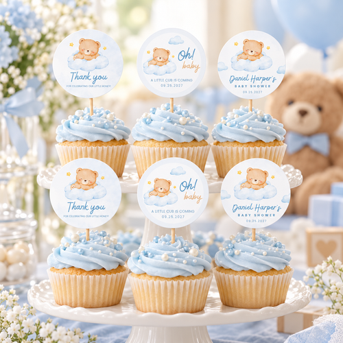 Little Bear cupcake toppers on blue frosted cupcakes on a cake stand at a teddy bear baby shower
