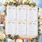 Filled-in Little Bear wishes for baby cards pinned on a white wishes board framed with eucalyptus at a boy baby shower