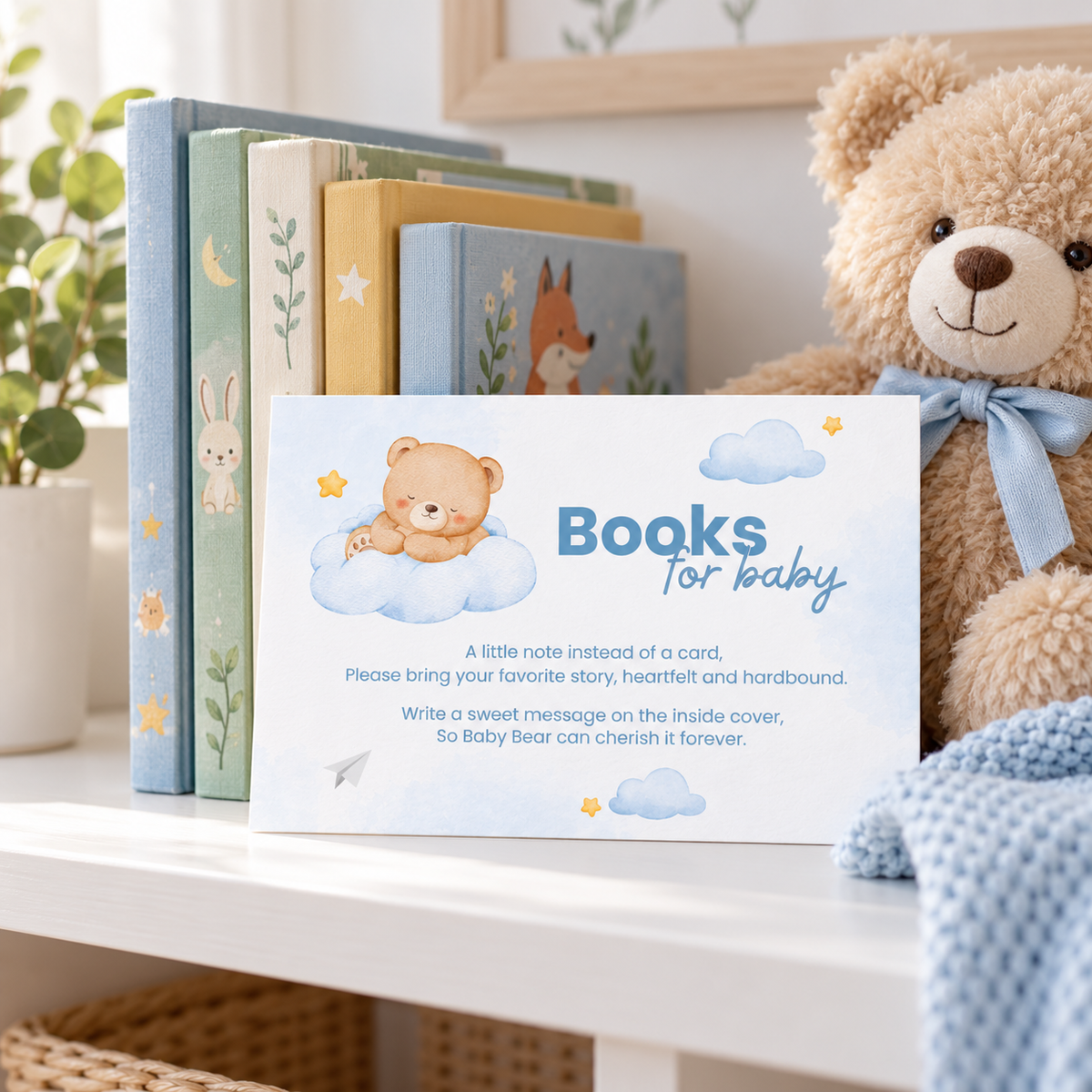 Books for baby card leaning against a stack of children's picture books next to a teddy bear