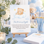 Little Bear The Price is Right game sign on a small easel next to game cards and blue pencils