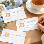 Guest filling in a Little Bear baby shower game ticket next to a cup of tea