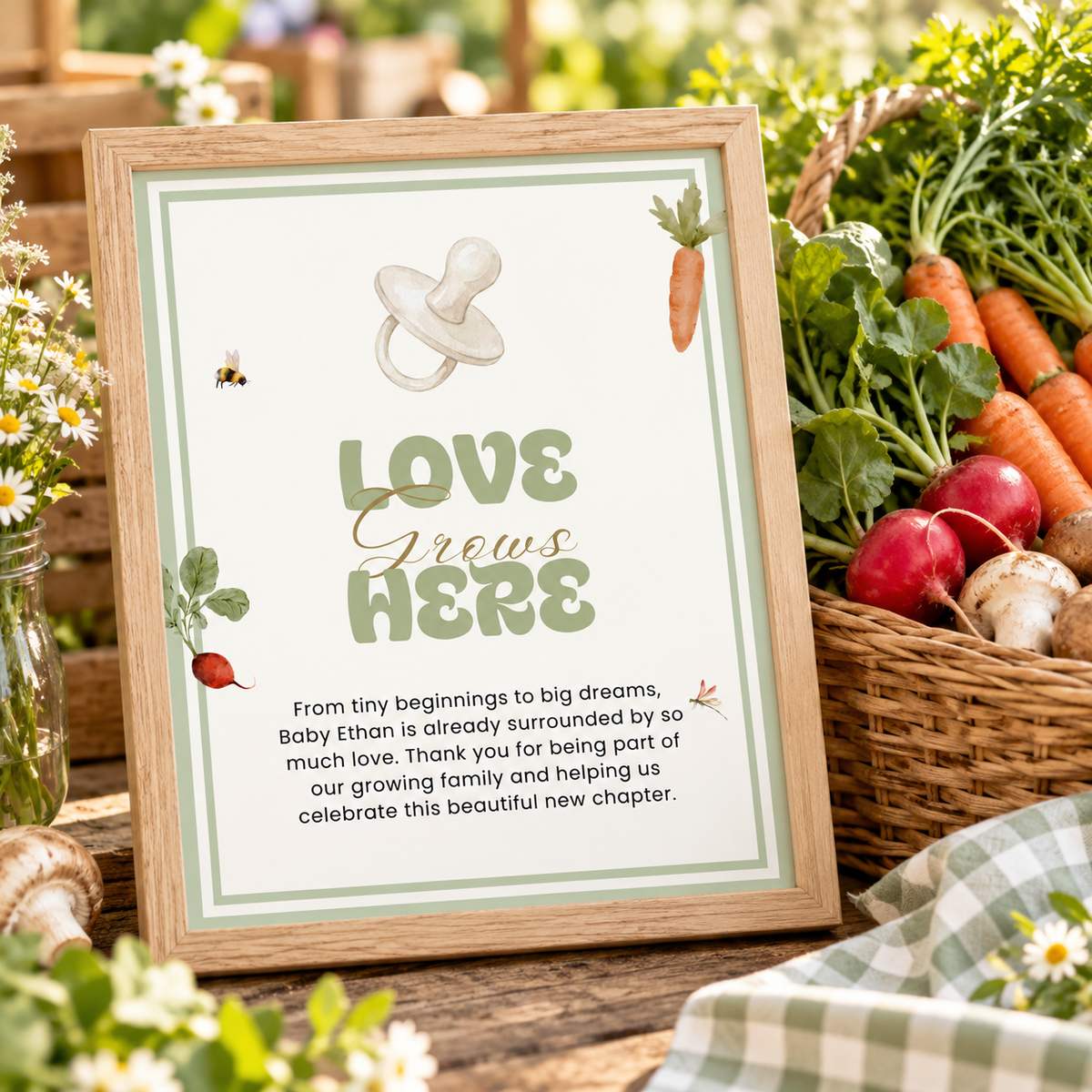 Love Grows Here baby shower sign in a frame next to a basket of fresh vegetables