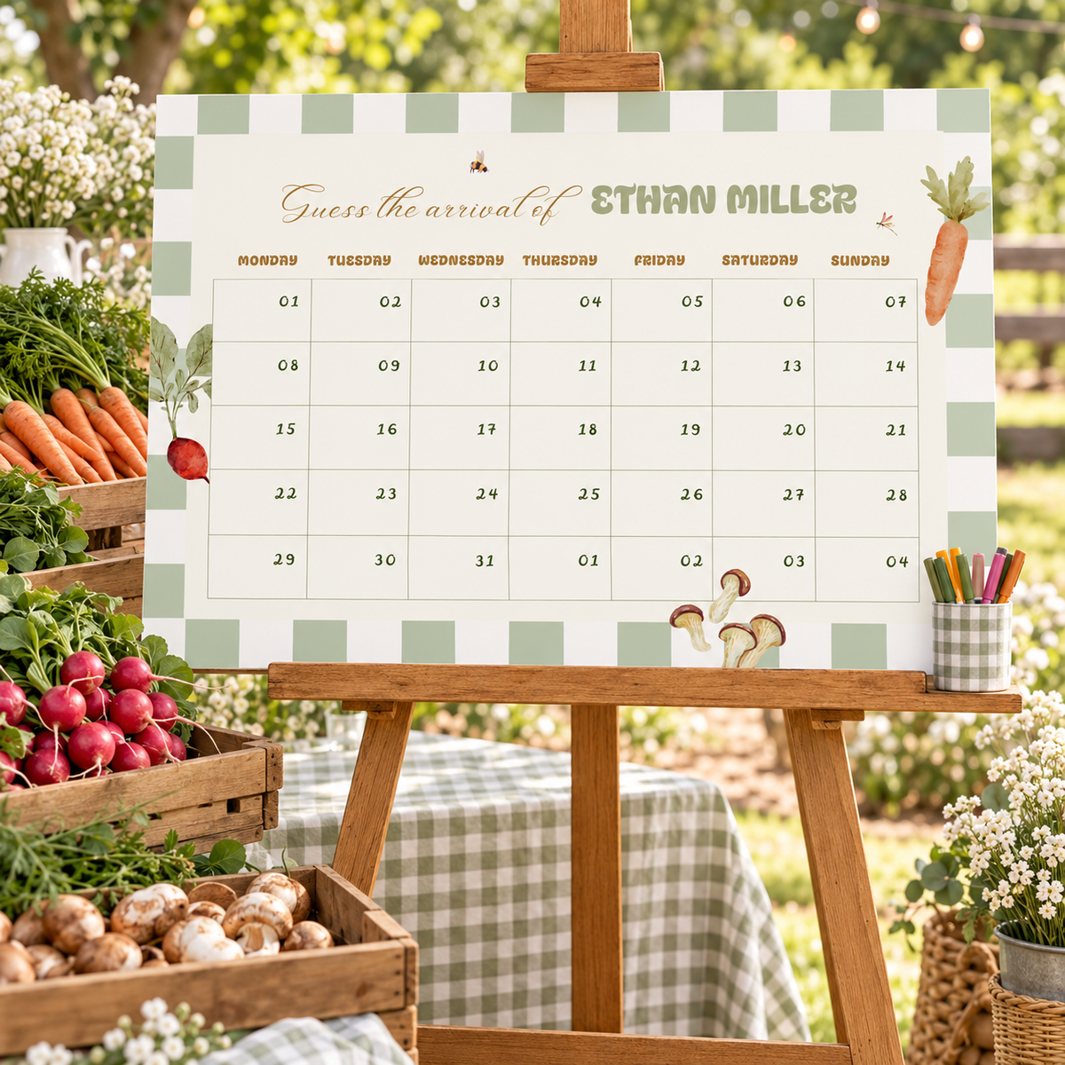 Locally Grown due date calendar poster on a wooden easel at a farmers market baby shower with produce crates and a cup of markers